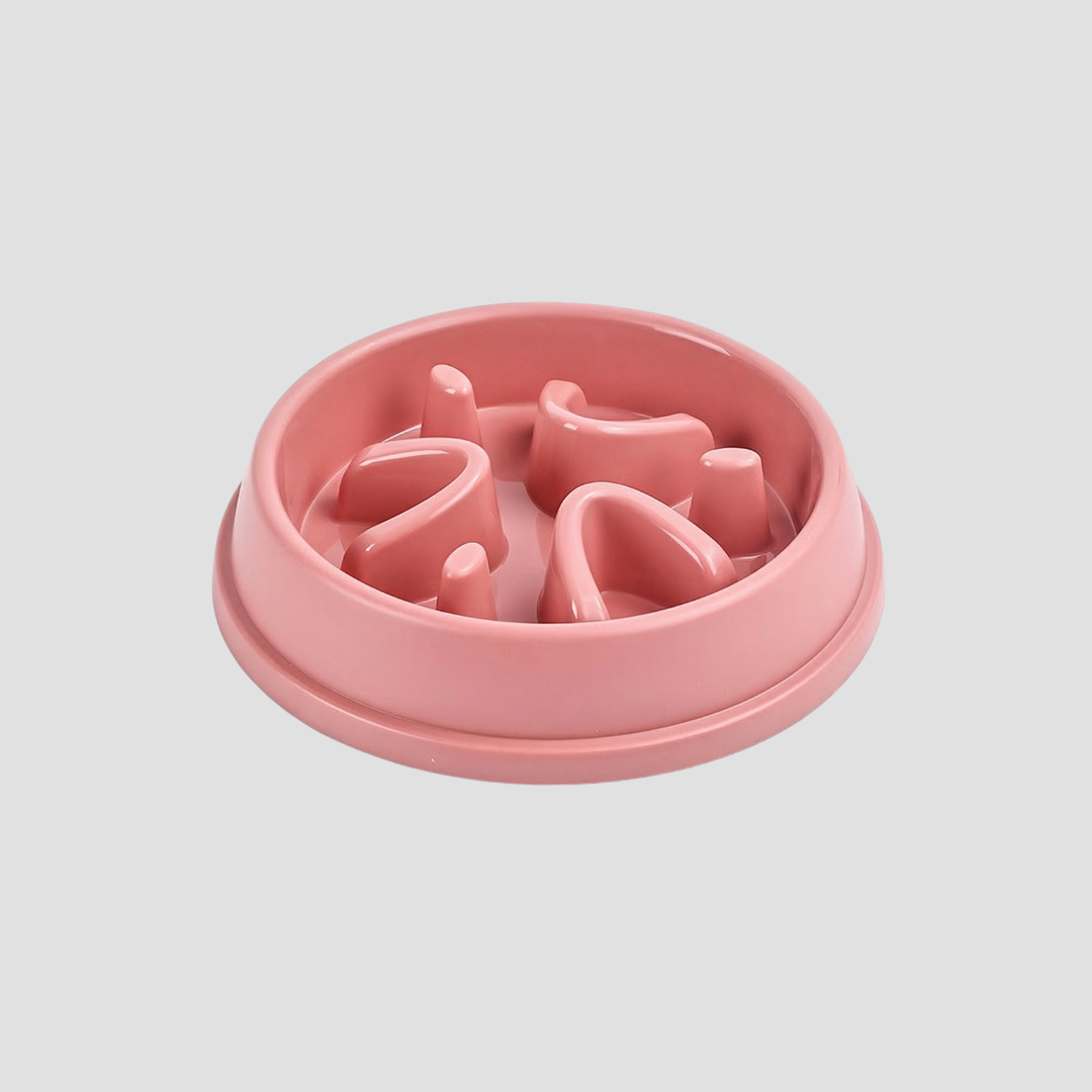 Pink pet feeder with a textured surface on a light gray background